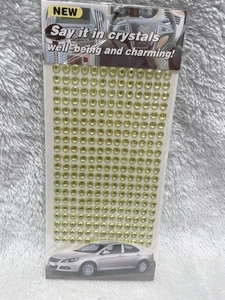 Macro shot of 3mm yellow acrylic rhinestone stickers on a transparent sheet for DIY decor