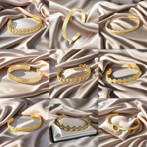 Macro shot of gold hollow-out bangle collection with diverse floral and wave patterns