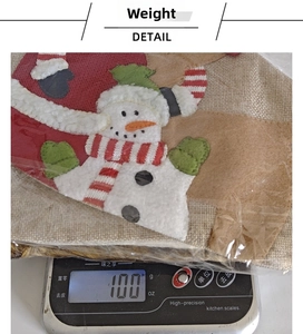 Detail showing a Christmas snowman stocking weighed on a digital scale for 100g accuracy