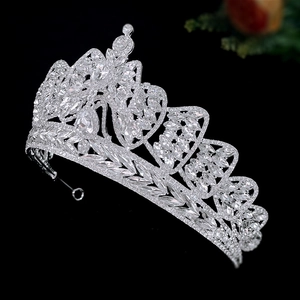 Elegant silver bridal crown with crystal bow and flower patterns on black background