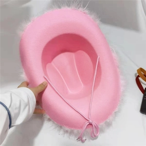 Pink western cowboy hat with white faux feather trim and adjustable chin strap