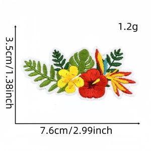 Detailed view of tropical floral embroidery patch with hibiscus and palm leaves