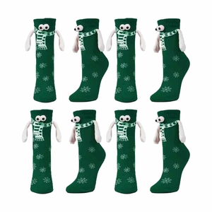 Detail of green Christmas socks with 3D cartoon eyes and white snowflake patterns