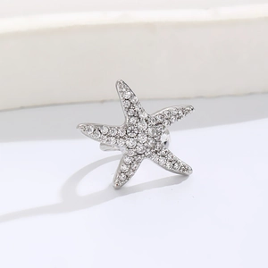 Elegant silver starfish ear cuff with micro-pave cubic zirconia on a gray background