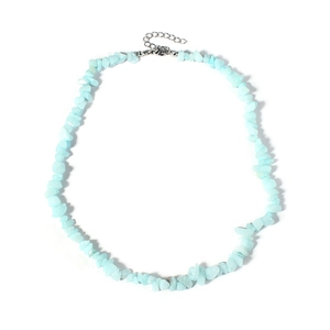Close-up of irregular light blue natural crystal stone chips on a silver-tone necklace