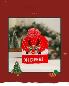 Detail of red Christmas beanie featuring LED glowing reindeer and soft pompom
