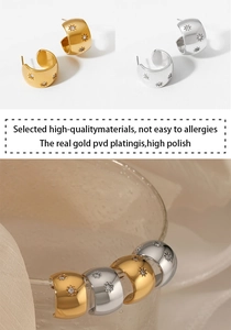 Detail of PVD gold plated C-shape earrings with star engraving and white zircon inlay