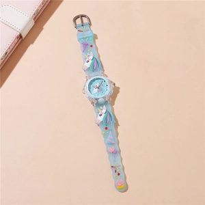 Detail view of light blue unicorn kids watch with 3D silicone party icons and soft wave strap