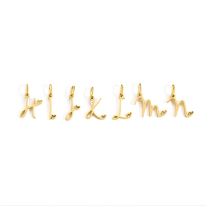 Detail view of gold-plated stainless steel letter charms H to N with heart accents