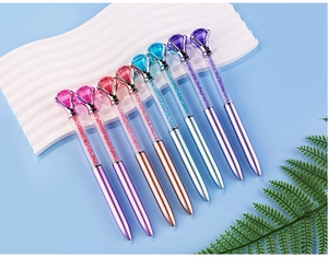 Close-up of diamond crystal ballpoint pens with shimmering quicksand and metallic finish