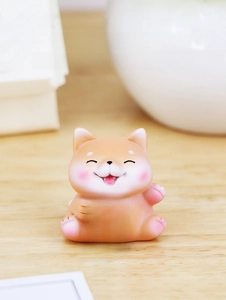 Close-up of cute Shiba Inu resin figurine holding a Mahjong tile for desk decor