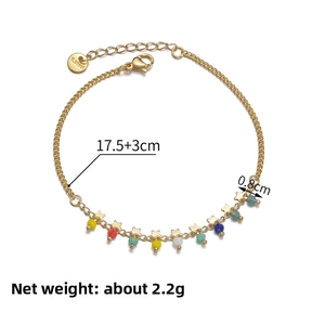 Detail of colorful beads and gold star pendant on a 14K stainless steel tassel bracelet