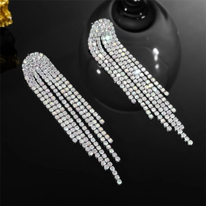 Detail shot of elegant long silver tassel earrings with shimmering rhinestone fringes