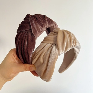 Detail of velvet knotted headbands in coffee brown and champagne gold with ribbed texture