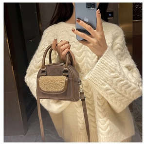 Brown suede crossbody bag with beige fleece pocket shown in a stylish mirror selfie