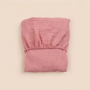 Pink double-layer cotton gauze bassinet sheet with elastic band and soft wrinkled texture