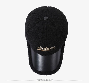 Close-up of black lamb wool baseball cap with gold embroidery and leather brim details