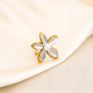 Macro shot of gold-plated stainless steel ring with 5-petal flower and pearl accent