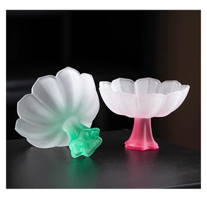 Detail of lotus-shaped frosted glass tea cups with green and pink gradient finishes