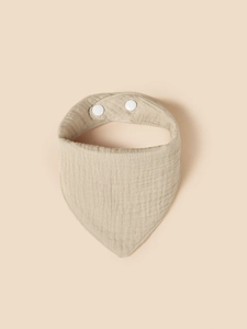 Detail of soft muslin cotton baby bib with adjustable double plastic snap buttons