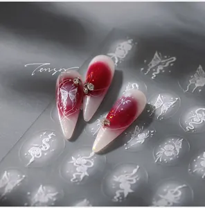 Macro view of 3D embossed white butterfly and floral nail stickers with glitter details
