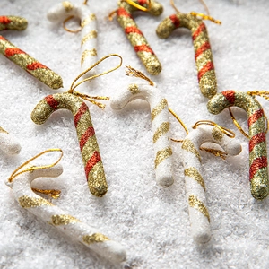 Glittery Christmas candy cane ornaments with gold strings for tree decorations