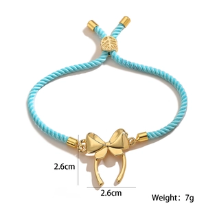Detail shot of blue braided rope bracelet with 2.6cm golden bow pendant and weight info