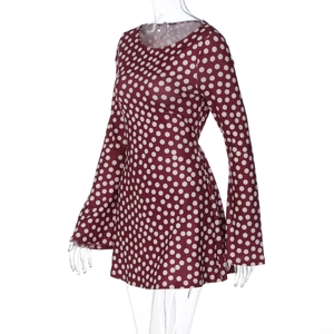 Detail view of burgundy polka dot long sleeve dress with flared cuffs on ghost mannequin