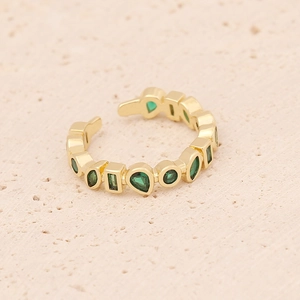 Gold adjustable ring with green zircon stones in drop and rectangle shapes on sandy base