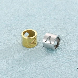 Cylindrical stainless steel alphabet A hollow charms in gold and silver finish