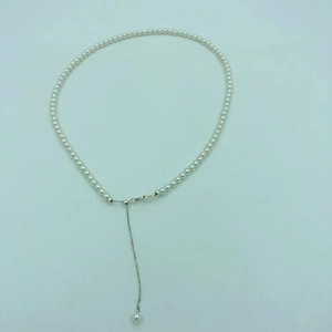 Detailed view of white pearl necklace with S925 silver lobster clasp and extension chain