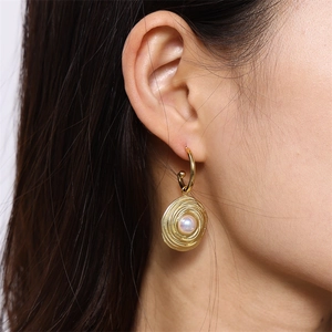 Elegant gold screw design hoop earrings with center pearl accent for women shown on model