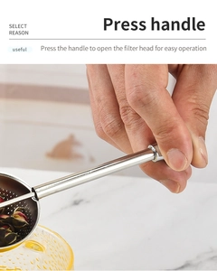 Detailed view of hand pressing the 304 stainless steel tea infuser with mesh filter ball