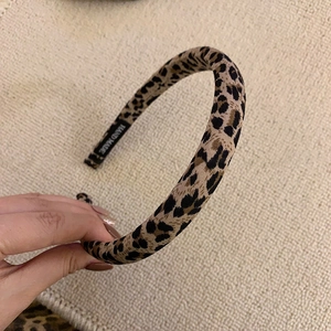 Detailed shot of a vintage leopard print slim headband with a handmade inner label