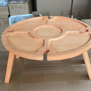 Detailed top view of a portable wooden picnic table with divided sections and wine glass slots