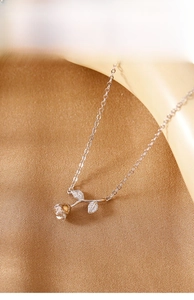 Detail view of S925 sterling silver rose pendant with sparkling zircons on satin background