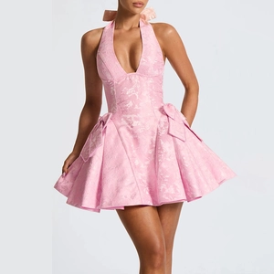 Close-up of pink halter V-neck jacquard dress featuring side bows and pleated skirt details
