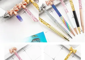 Close-up of glitter floating in liquid oil inside the creative bow-knot metal ballpoint pen