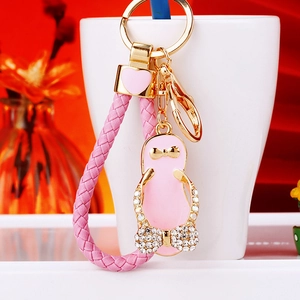 Close-up of pink flip-flop keychain with rhinestones and bow on a white cup rim