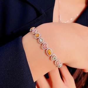 Macro detail of luxury colorful gemstone bracelet with teardrop stones on wrist