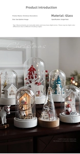 Detail of warm LED glass dome ornament with wooden base and festive holiday figures