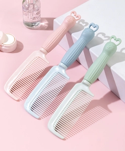 Detailed view of pastel colored hair combs with cute cartoon rabbit handles for girls