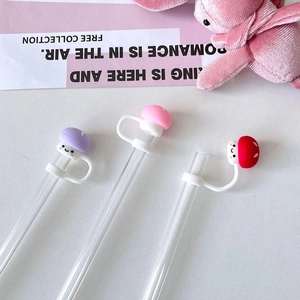 Close-up of cute mushroom silicone straw covers in purple, pink and red for Stanley cups