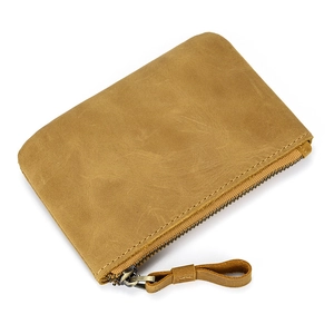 Close-up of brown crazy horse leather coin pouch showing natural grain and metal zipper