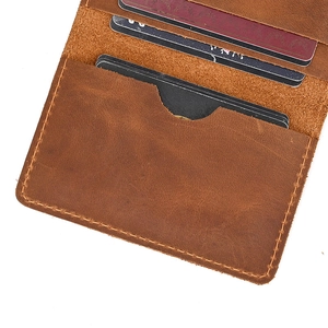 Close-up of brown crazy horse leather wallet detail showing multiple card slots