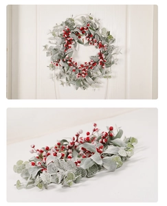 Close-up of frosted Christmas wreath with red berries and snowy eucalyptus on white wood