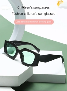 Macro shot of matte black hexagonal frames and light green lenses of kids sunglasses
