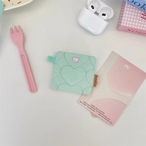 Mint green quilted headphone pouch with heart button and compact portable design