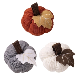 Three-piece knitted pumpkin set in orange, grey and white for autumn harvest decor