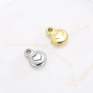 Golden and silver heart pendants in round stainless steel with relief patterns
